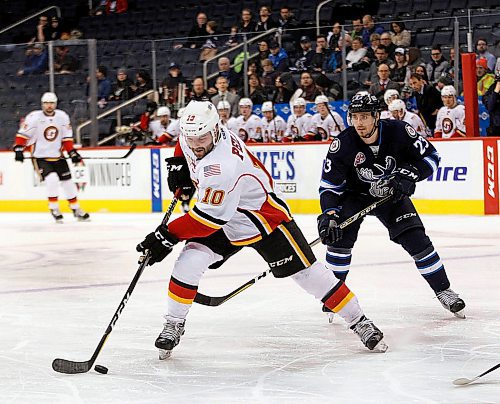 PHIL HOSSACK / WINNIPEG FREE PRESS - Stockton Heat #10 Rod Pelly works the puck away from Manitoba Moose #23 Maichael Spacek THursday evening at Bell MTS Place. - March 22, 2018