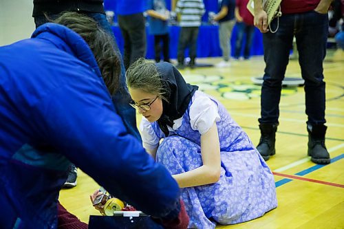 MIKAELA MACKENZIE / WINNIPEG FREE PRESS
Kenzie Kleinsasser, 13, does a quick repair before doing another match at the annual Manitoba Robot Games at the Technical Vocational High School in Winnipeg on Saturday, March 24, 2018.
Mikaela MacKenzie / Winnipeg Free Press 24, 2018.