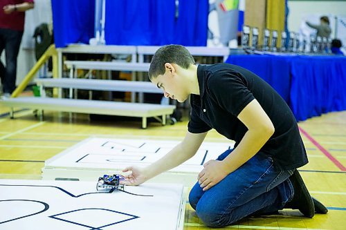 MIKAELA MACKENZIE / WINNIPEG FREE PRESS
Joseph Bernardin, 14, practices with his robot before competing at the annual Manitoba Robot Games at the Technical Vocational High School in Winnipeg on Saturday, March 24, 2018. This robot follows a black line on a white surface.
Mikaela MacKenzie / Winnipeg Free Press 24, 2018.