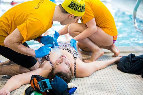 MIKAELA MACKENZIE / WINNIPEG FREE PRESS
Volunteer "victim" Liz Plett is given first aid by participants in the Manitoba Lifeguard Championships at the St. James Centennial Pool in Winnipeg on Saturday, March 24, 2018.
Mikaela MacKenzie / Winnipeg Free Press 24, 2018.