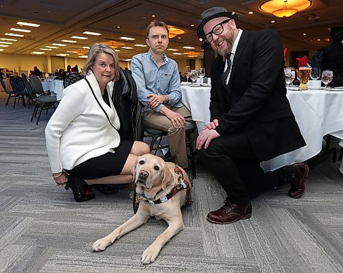 JASON HALSTEAD / WINNIPEG FREE PRESS

(NOTE: Guest speaker asked not to have his last name nor his guide dog's published)
L-R: Margot Ross (manager of philanthropy, CNIB Manitoba), CNIB guest speaker Tom and event emcee Ace Burpee with Tom's guide dog at the Canadian National Institute for the Blind's Eye on the Arts benefit auction on March 1, 2018 at the RBC Convention Centre Winnipeg. (See Social Page)