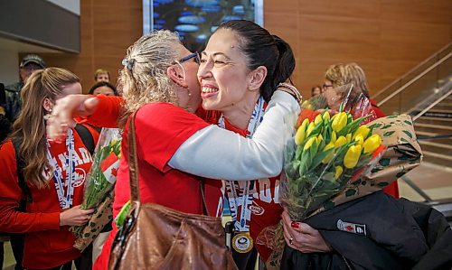 MIKE DEAL / WINNIPEG FREE PRESS
Annette Giguere past president of the St. Vital Curling Club greets Jill Officer a member of the Jennifer Jones team that won the World Women's Curling Championship in North Bay, Ontario, as she arrives home to Winnipeg at the airport Monday afternoon.
180326 - Monday, March 26, 2018.