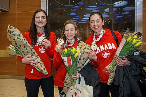 MIKE DEAL / WINNIPEG FREE PRESS
Members of the Jennifer Jones team (from left), Shannon Birchard, Kaitlyn Lawes, and Jill Officer, that won the World Women's Curling Championship in North Bay, Ontario, arrive home to Winnipeg and are greeted by a legion of fans Monday afternoon.
180326 - Monday, March 26, 2018.