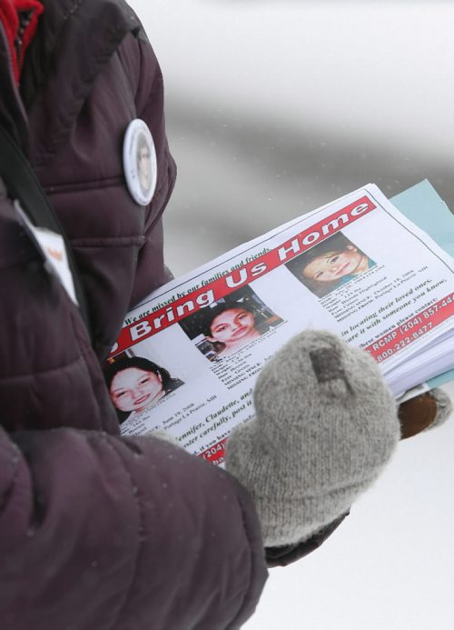 Brandon Sun Heather Sharpe holds an armful of flyers with the pictures of three missing Manitoba women which where handed out during a rally held on Tuesday. FOR IAN (Bruce Bumstead/Brandon Sun)