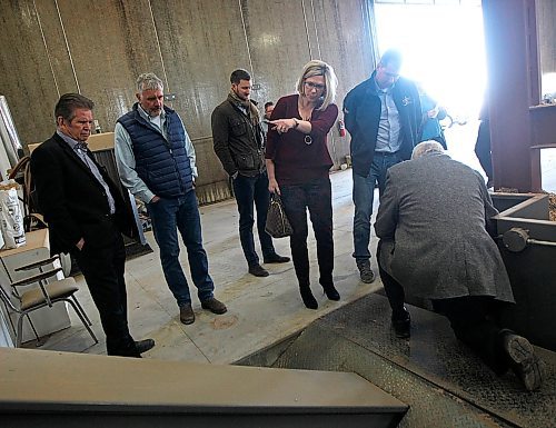 PHIL HOSSACK/Winnipeg Free Press - Minister Rochelle Squires (centre) gestures as she hears how biomass fuel (wood chips) is fed into the combustion chamber of the giant furnas Tuesday afternoon on the Vermillion Hutterite Colony near Sanford Mb. The community uses Biomass combustion to heat about 100,000 sq ft of barns and outbuildings. Homes on the colony are heated with GeoThermal technology. (I beleive Raymond is the origional inventor of these particular Biomass units. See Bill Redekop story. March27, 2018