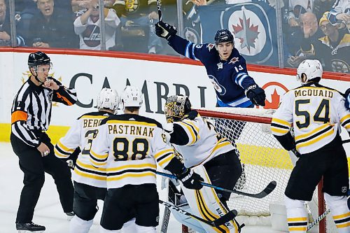 Winnipeg Jets' Brandon Tanev (13) questions why his goal on  Boston Bruins goaltender Anton Khudobin (35) was denied during first period NHL action in Winnipeg on Tuesday, March 27, 2018. THE CANADIAN PRESS/John Woods