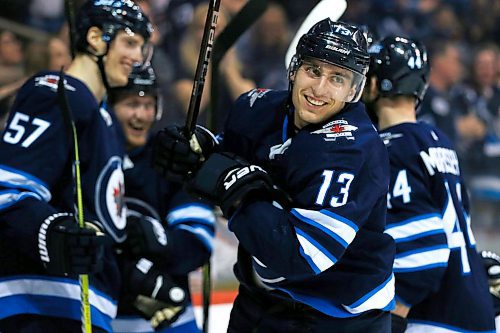 Winnipeg Jets' Brandon Tanev (13) celebrates his second goal of the game against the  Boston Bruins during second period NHL action in Winnipeg on Tuesday, March 27, 2018. THE CANADIAN PRESS/John Woods