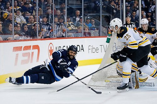 Winnipeg Jets' Dustin Byfuglien (33) loses the edge as he attempts the wrap around on  Boston Bruins goaltender Anton Khudobin (35) and Brandon Carlo (25) during second period NHL action in Winnipeg on Tuesday, March 27, 2018. THE CANADIAN PRESS/John Woods