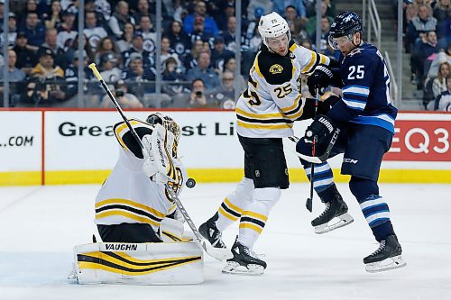 Boston Bruins goaltender Anton Khudobin (35) saves the tip by Winnipeg Jets' Paul Stastny (25) as Bruins' Brandon Carlo (25) defends during second period NHL action in Winnipeg on Tuesday, March 27, 2018. THE CANADIAN PRESS/John Woods
