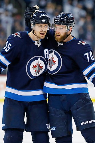 Winnipeg Jets' Joe Morrow (70) celebrates his first goal for the Jets with Mark Scheifele (55) during second period NHL action in Winnipeg on Tuesday, March 27, 2018. THE CANADIAN PRESS/John Woods