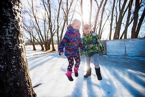 MIKAELA MACKENZIE / WINNIPEG FREE PRESS
Kyla (left) and Adam Nobel jump to crack ice layers on their backyard rink in Transcona in Winnipeg on Wednesday, March 28, 2018.
Mikaela MacKenzie / Winnipeg Free Press 28, 2018.