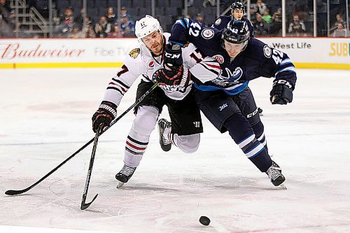 PHIL HOSSACK / WINNIPEG FREE PRESS - Rockford Icehog #17 Lance Bouma and Manitoba Moose #42 Peter Stoykewych scramble for the puck deep in the Moose end Wednesday evening at Bell MTS Place  - March 28, 2018