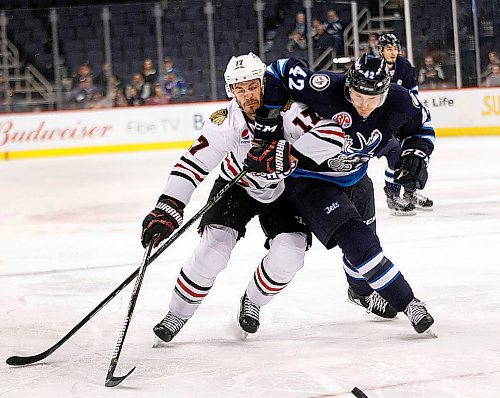 PHIL HOSSACK / WINNIPEG FREE PRESS - Rockford Icehog #17 Lance Bouma and Manitoba Moose #42 Peter Stoykewych scramble for the puck deep in the Moose end Wednesday evening at Bell MTS Place  - March 28, 2018