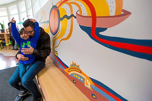 MIKAELA MACKENZIE / WINNIPEG FREE PRESS
Artist Jordan Stranger and his son, Jaymee, pose in front of a mural he created as part of the Community Mural Mentorship in Winnipeg on Thursday, March 29, 2018. The program saw professional artists engage with local youth and families in the North End to create two collaborative murals that reflect their communities.
Mikaela MacKenzie / Winnipeg Free Press 29, 2018.