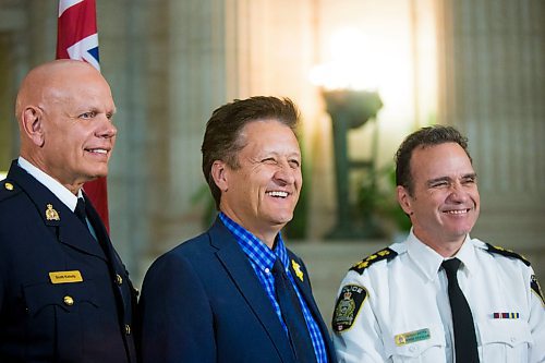 MIKAELA MACKENZIE / WINNIPEG FREE PRESS
Manitoba RCMP Assistant Commissioner Scott Kolody (left), Infrastructure Minister Ron Schuler, and Chief of Police Danny Smyth pose for a picture after announcing the expansion of Alert Ready to wireless devices at the Manitoba Legislative Building in Winnipeg on Tuesday, April 3, 2018. 
Mikaela MacKenzie / Winnipeg Free Press 03, 2018.