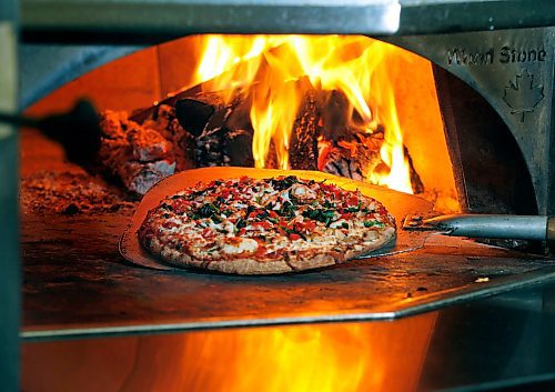PHIL HOSSACK / WINNIPEG FREE PRESS - A "California" pizza comes out of the wood fired oven at Santa Ana pizzeria.....re:Munch Madness finalist.....See story. April 5, 2018