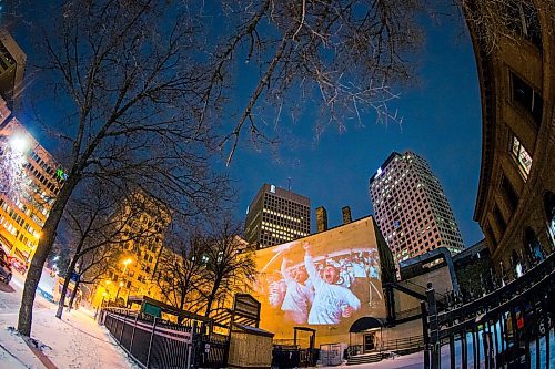 MIKAELA MACKENZIE / WINNIPEG FREE PRESS
Jets fan photos projected onto downtown buildings in Winnipeg on Thursday, April 5, 2018. 
Mikaela MacKenzie / Winnipeg Free Press 2018.