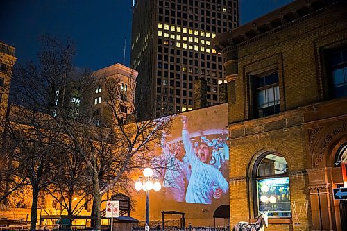 MIKAELA MACKENZIE / WINNIPEG FREE PRESS
Jets fan photos projected onto downtown buildings in Winnipeg on Thursday, April 5, 2018. 
Mikaela MacKenzie / Winnipeg Free Press 2018.