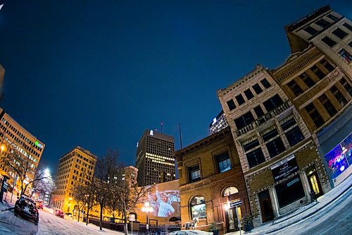 MIKAELA MACKENZIE / WINNIPEG FREE PRESS
Jets fan photos projected onto downtown buildings in Winnipeg on Thursday, April 5, 2018. 
Mikaela MacKenzie / Winnipeg Free Press 2018.