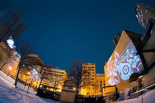 MIKAELA MACKENZIE / WINNIPEG FREE PRESS
Jets fan photos projected onto downtown buildings in Winnipeg on Thursday, April 5, 2018. 
Mikaela MacKenzie / Winnipeg Free Press 2018.