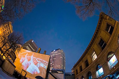 MIKAELA MACKENZIE / WINNIPEG FREE PRESS
Jets fan photos projected onto downtown buildings in Winnipeg on Thursday, April 5, 2018. 
Mikaela MacKenzie / Winnipeg Free Press 2018.