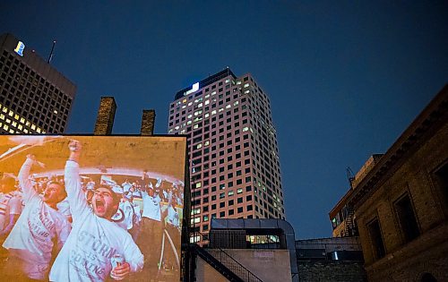 MIKAELA MACKENZIE / WINNIPEG FREE PRESS
Jets fan photos projected onto downtown buildings in Winnipeg on Thursday, April 5, 2018. 
Mikaela MacKenzie / Winnipeg Free Press 2018.