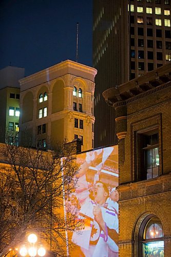 MIKAELA MACKENZIE / WINNIPEG FREE PRESS
Jets fan photos projected onto downtown buildings in Winnipeg on Thursday, April 5, 2018. 
Mikaela MacKenzie / Winnipeg Free Press 2018.