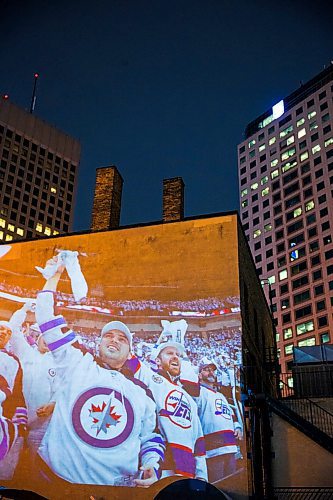 MIKAELA MACKENZIE / WINNIPEG FREE PRESS
Jets fan photos projected onto downtown buildings in Winnipeg on Thursday, April 5, 2018. 
Mikaela MacKenzie / Winnipeg Free Press 2018.