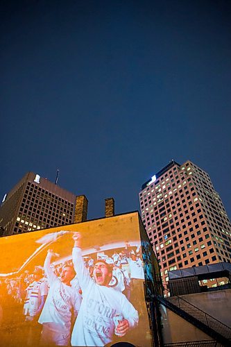 MIKAELA MACKENZIE / WINNIPEG FREE PRESS
Jets fan photos projected onto downtown buildings in Winnipeg on Thursday, April 5, 2018. 
Mikaela MacKenzie / Winnipeg Free Press 2018.