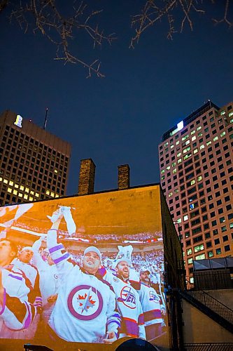 MIKAELA MACKENZIE / WINNIPEG FREE PRESS
Jets fan photos projected onto downtown buildings in Winnipeg on Thursday, April 5, 2018. 
Mikaela MacKenzie / Winnipeg Free Press 2018.