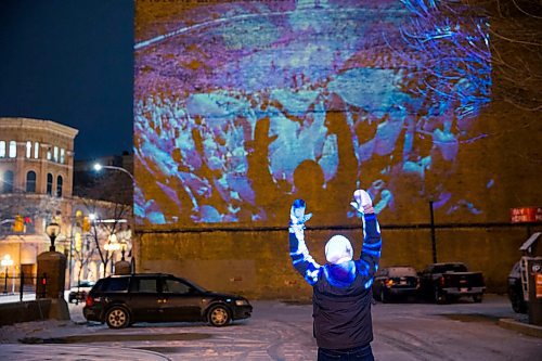 MIKAELA MACKENZIE / WINNIPEG FREE PRESS
Jets fan photos projected onto downtown buildings in Winnipeg on Thursday, April 5, 2018. 
Mikaela MacKenzie / Winnipeg Free Press 2018.