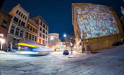 MIKAELA MACKENZIE / WINNIPEG FREE PRESS
Jets fan photos projected onto downtown buildings in Winnipeg on Thursday, April 5, 2018. 
Mikaela MacKenzie / Winnipeg Free Press 2018.