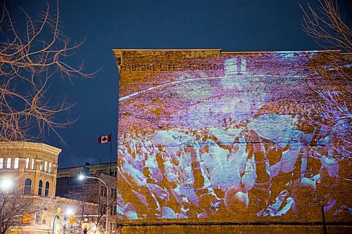 MIKAELA MACKENZIE / WINNIPEG FREE PRESS
Jets fan photos projected onto downtown buildings in Winnipeg on Thursday, April 5, 2018. 
Mikaela MacKenzie / Winnipeg Free Press 2018.