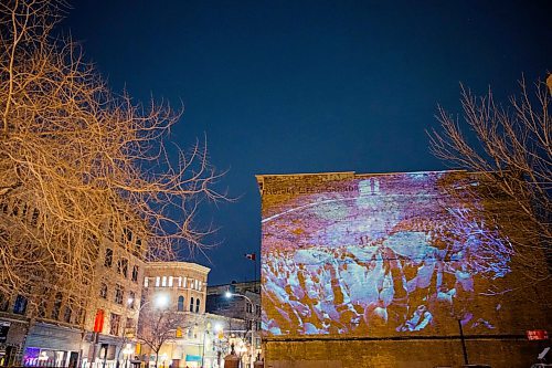 MIKAELA MACKENZIE / WINNIPEG FREE PRESS
Jets fan photos projected onto downtown buildings in Winnipeg on Thursday, April 5, 2018. 
Mikaela MacKenzie / Winnipeg Free Press 2018.