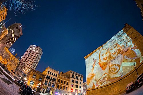 MIKAELA MACKENZIE / WINNIPEG FREE PRESS
Jets fan photos projected onto downtown buildings in Winnipeg on Thursday, April 5, 2018. 
Mikaela MacKenzie / Winnipeg Free Press 2018.