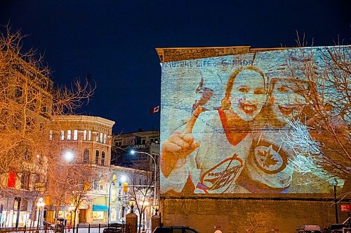 MIKAELA MACKENZIE / WINNIPEG FREE PRESS
Jets fan photos projected onto downtown buildings in Winnipeg on Thursday, April 5, 2018. 
Mikaela MacKenzie / Winnipeg Free Press 2018.