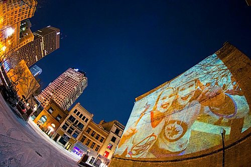 MIKAELA MACKENZIE / WINNIPEG FREE PRESS
Jets fan photos projected onto downtown buildings in Winnipeg on Thursday, April 5, 2018. 
Mikaela MacKenzie / Winnipeg Free Press 2018.