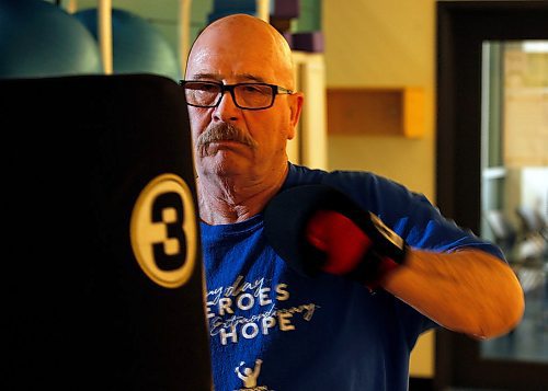 PHIL HOSSACK / WINNIPEG FREE PRESS - Retired cop, Doug Lloyd  takes on a punching bag Friday afternoon at the Rady Centre. He visualizes "Parkinsons" on the bag as he takes a round out of it and the disease. See Joel Schlessinger's story. - April 6, 2018