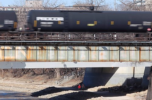 TREVOR HAGAN / WINNIPEG FREE PRESS
People walk along the river trail next to the Assiniboine River at The Forks, Sunday, April 8, 2018.