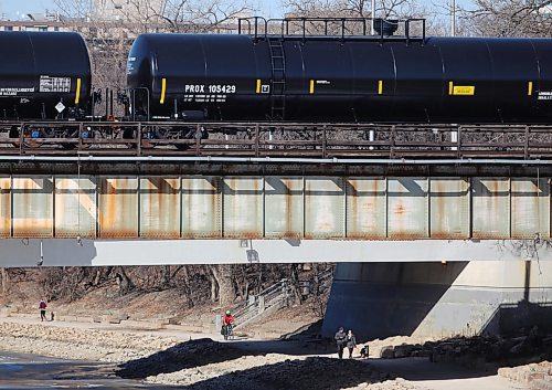 TREVOR HAGAN / WINNIPEG FREE PRESS
People walk along the river trail next to the Assiniboine River at The Forks, Sunday, April 8, 2018.