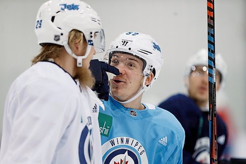 Winnipeg Jets' Patrik Laine (29) and Jack Roslovic (52) joke around during a round one playoff practice in Winnipeg on Monday, April 9, 2018. THE CANADIAN PRESS/John Woods