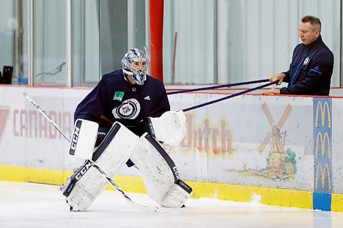 Winnipeg Jets' goaltender Connor Hellebuyck (37) warms up during a round one playoff practice in Winnipeg on Monday, April 9, 2018. THE CANADIAN PRESS/John Woods