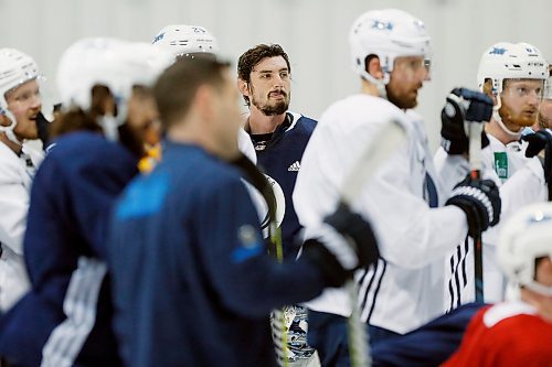 Winnipeg Jets goaltender Connor Hellebuyck (37) listens to the coach during a round one playoff practice in Winnipeg on Monday, April 9, 2018. THE CANADIAN PRESS/John Woods
