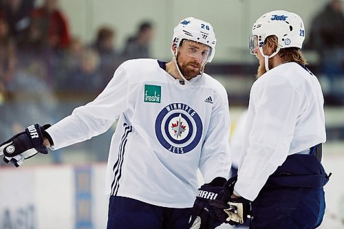 Winnipeg Jets' Bryan Little (18) and Patrik Laine (29) talk during a round one playoff practice in Winnipeg on Monday, April 9, 2018. THE CANADIAN PRESS/John Woods