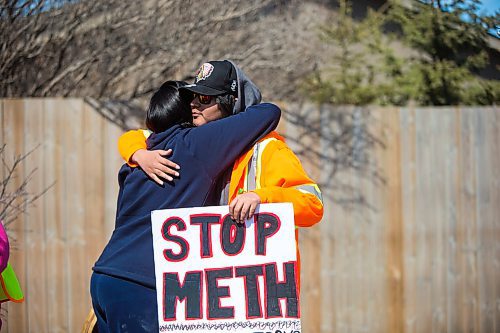 MIKAELA MACKENZIE / WINNIPEG FREE PRESS
Camille Munro (left) hugs Quentin Harper as the #stopmeth walk travels down Main Street in Rivergrove in Winnipeg on Monday, April 9, 2018. 
Mikaela MacKenzie / Winnipeg Free Press 2018.