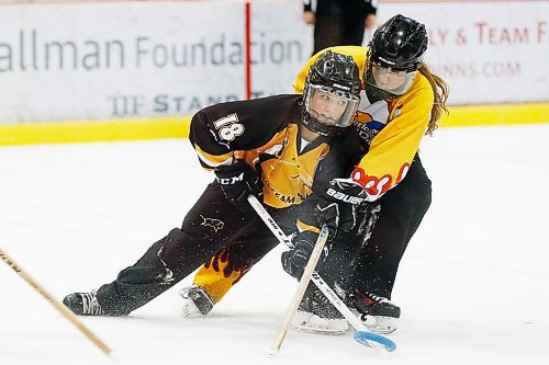 JOHN WOODS / WINNIPEG FREE PRESS
Manitoba's Alana Lesperance (18) attempts to get a shot away against Waterloo Wildfire defence in the Canadian Ringette Championships in Winnipeg Monday, April 9, 2018.