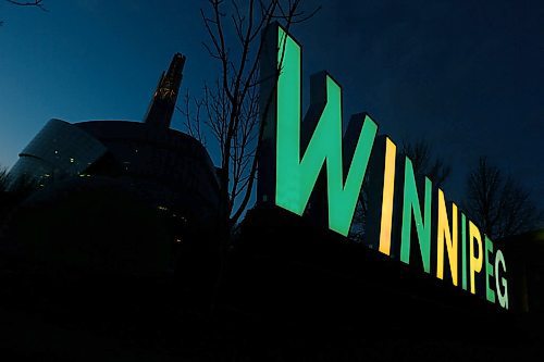 JOHN WOODS / WINNIPEG FREE PRESS
Winnipeg sign at the Forks is lit in green in yellow in honour of the Humboldt Broncos bus accident victims Monday, April 9, 2018.