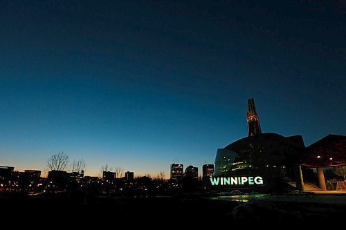 JOHN WOODS / WINNIPEG FREE PRESS
Winnipeg sign at the Forks is lit in green in yellow in honour of the Humboldt Broncos bus accident victims Monday, April 9, 2018.