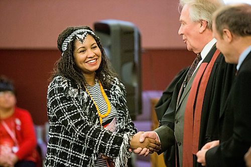 MIKAELA MACKENZIE / WINNIPEG FREE PRESS
Talile Brhanu shakes Dwight MacAullay's hand at a special citizenship ceremony at the VIA Rail Station in Winnipeg on Tuesday, April 10, 2018. 
Mikaela MacKenzie / Winnipeg Free Press 2018.