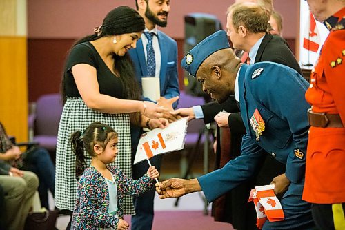 MIKAELA MACKENZIE / WINNIPEG FREE PRESS
Three-year-old Guneev Jaswal takes a Canadian flag from warrant officer Geoffrey Stehens at a special citizenship ceremony at the VIA Rail Station in Winnipeg on Tuesday, April 10, 2018. 
Mikaela MacKenzie / Winnipeg Free Press 2018.
